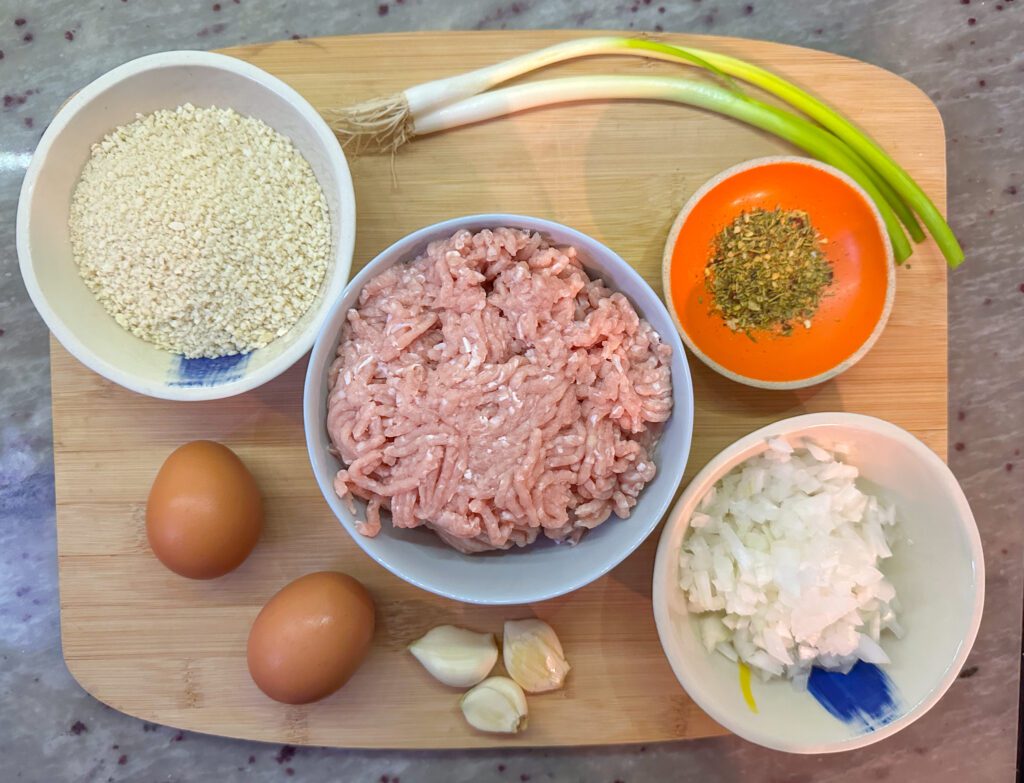 Air Fry Meatball ingredients including ground chicken, garlic, chopped white onion, all purpose seasonings, green onion, panko and eggs.